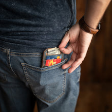 Load image into Gallery viewer, marbled blue shell cordovan leather minimalist wallet in back pocket with cards and money
